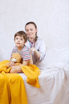 A child and a paediatrician in her cabinet