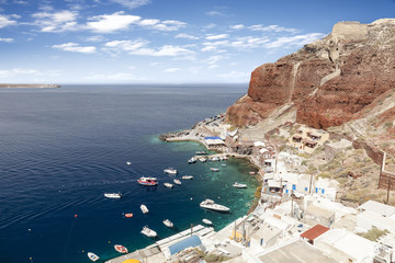 Port of Oia in Santorini with red hill