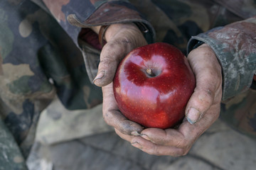 dirty hands and fresh apple
