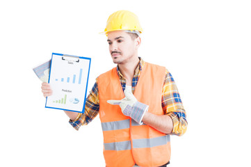 Attractive engineer pointing finger to a paper with sales chart