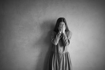 Sad woman covering her face