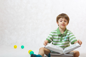 A boy is opening a book