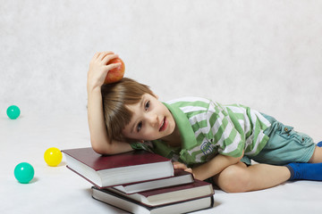 A boy and a pile of books