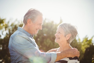 Side view of cheerful senior couple looking at each other