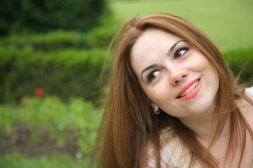 Naklejka premium A young attractive woman in an open air