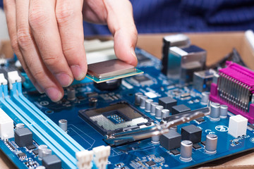 Assembling high performance personal computer, inserting CPU, processor into the motherboard...