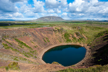 Volcanic crater Kerid with blue lake inside, at sunny day with beautiful sky, Iceland