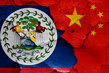 flags of Belize and China painted on cracked wall