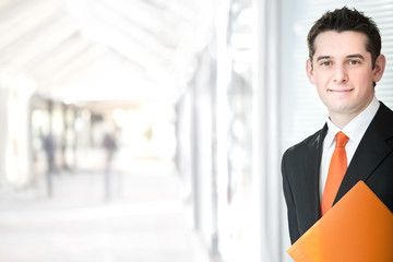 handsome elegant businessman with orange tie at office