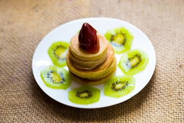 Pancakes with strawberry cream and kiwi fruit