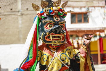 Fototapeta na wymiar An unidentified buddhist lamas dressed in mystical mask dancing Tsam mystery dance in time of Yuru Kabgyat Buddhist festival at Lamayuru Gompa