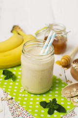 Banana smoothies in a glass jar on a white background