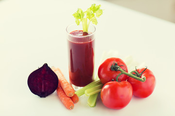 close up of fresh juice and vegetables on table