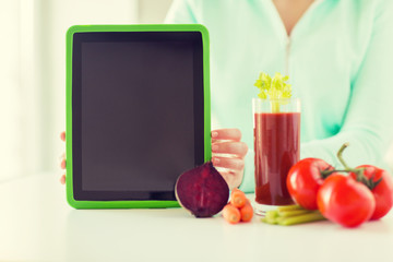 close up of woman with tablet pc and vegetables