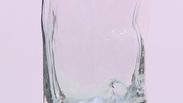 pouring water into a beaker on a white background