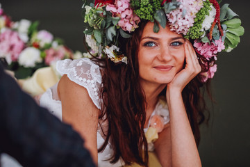 Obraz premium Close-up portrait of young beautiful woman in water holding her hands near the face. Woman with wreath of flowers