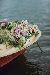 Decorated flowers on a wooden boat.