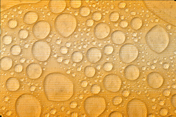 Water drops on yellow background