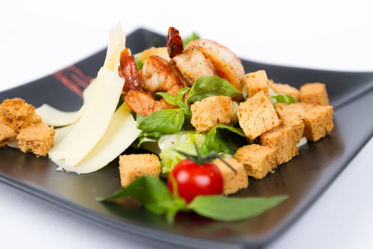 Close image of tasty cesar salad with shrimps