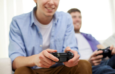 close up of friends playing video games at home