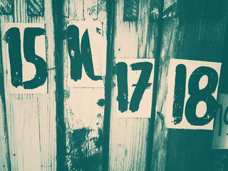 Hand-painted numbers in sequence on wood surfaces