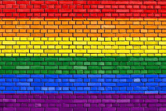 flag of the LGBT movement painted on brick wall