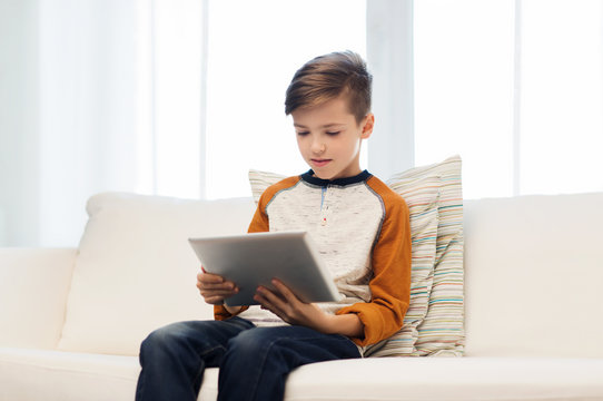 boy with tablet computer at home