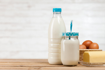 Obraz na płótnie Canvas Milk bottle on wooden table