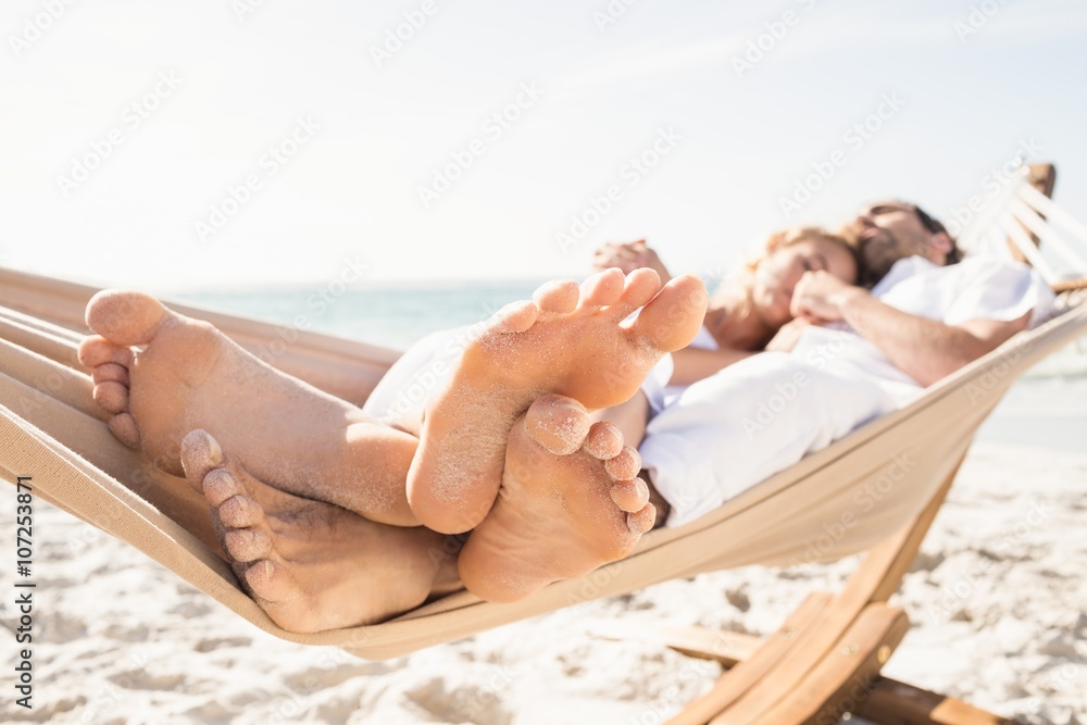 Wall mural Couple sleeping in hammock