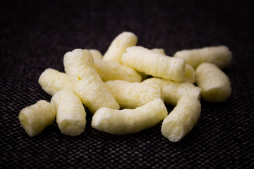 Corn snack on dark fabric base 
