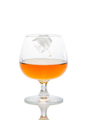 a glass of brandy on a white background.
