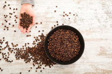 A womans hand at a table with coffee	