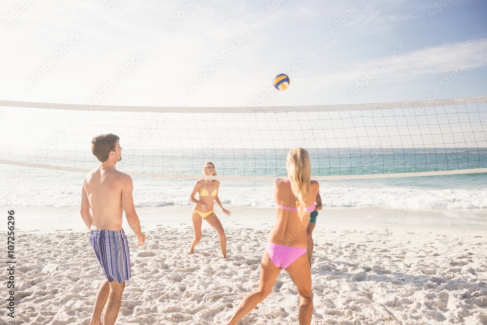 Wall mural friends playing beach volleyball