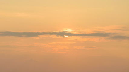 Fototapeta na wymiar Sunrise behind the cloud and orange sky