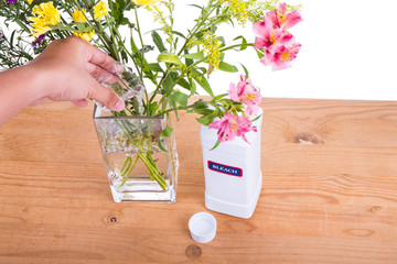 Add liquid bleach into vase filled with water to keep flowers fresher