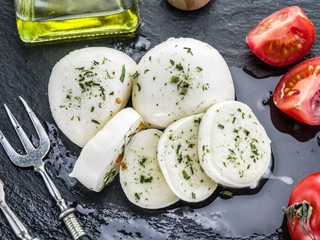 Mozzarella and tomatoes. Dark grey background.