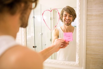 Boyfriend discovering a love message on the mirror