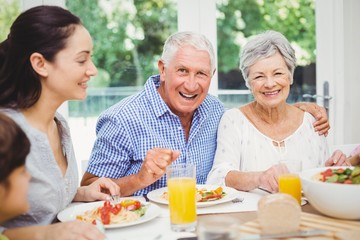 Portrait of smiling grandparents with family