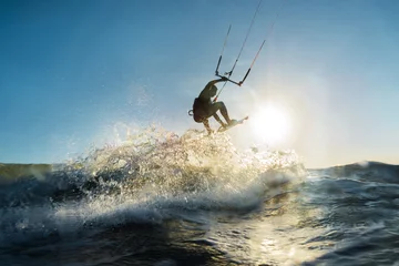 Zelfklevend Fotobehang Surfer jumping at the sunset © Raul Mellado