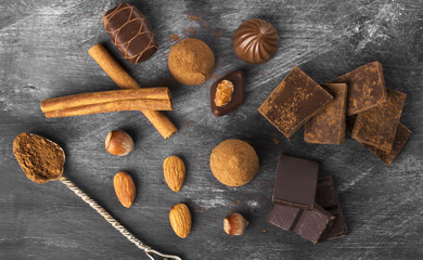 Various confectionery: chocolate, candies on a dark background