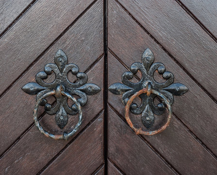 Old metal door knocker handles on church doors