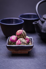 Chinese green tea balls with flowers, tea cup