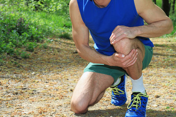 Obraz na płótnie Canvas Knee injury, Man runner with knee pain
