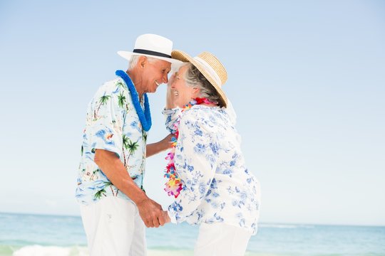 Senior couple looking at each other on the beach
