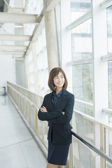 Attractive asian business woman smiling outside office