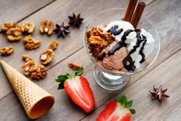 Ice cream sundae, waffle cone and sliced strawberry