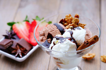 Ice cream sundae, chocolate and sliced strawberry
