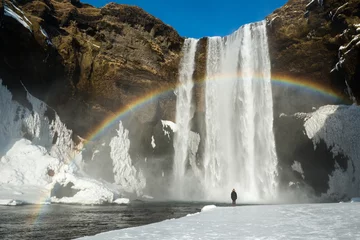 Zelfklevend Fotobehang Winter landscape, tourist by famous Skogafoss waterfall with rainbow, Iceland © dash1502
