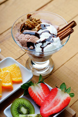 Ice cream sundae and sliced fruits
