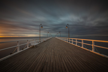 Beautiful landscape with wooden pier in Gdynia Orlowo at sunrise.